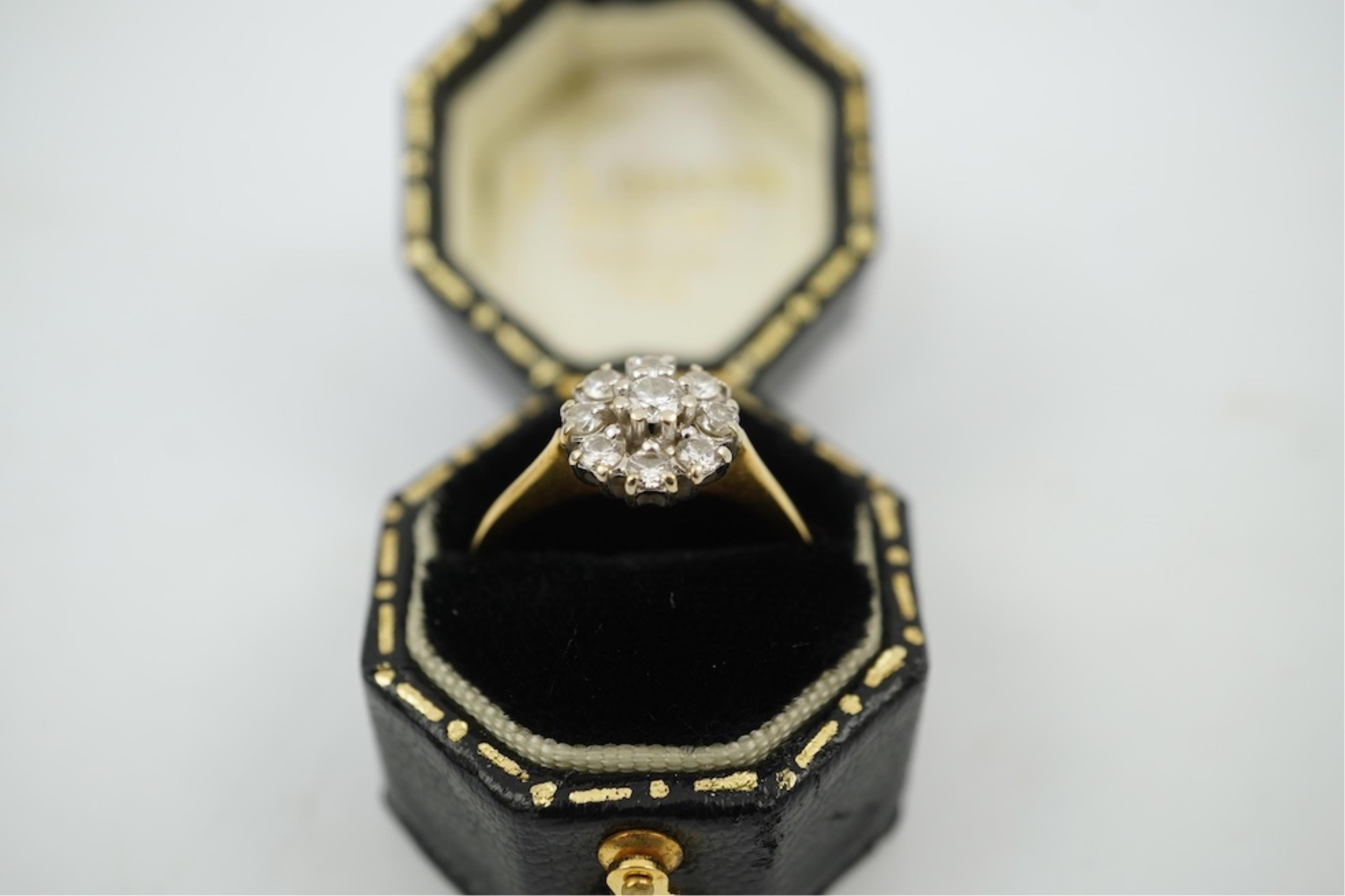 A modern 18ct gold and diamond set circular cluster ring, size M, gross weight 3.2 grams.